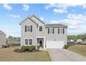 Two story home with gray siding, black shutters, attached garage, and manicured landscaping at 4655 Bluffton Ct, Cumming, GA 30028