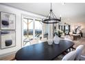 Bright dining room with modern lighting, stylish decor, and sliding glass doors to the outdoor patio at 7515 Woolf Way, Cumming, GA 30028