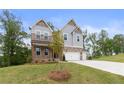 Attractive two-story home with a manicured lawn, covered porch, and a three-car garage at 7515 Woolf Way, Cumming, GA 30028