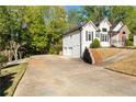 Spacious driveway leading to a two-car garage, adjacent to the side of this two-story home at 4080 Birch Bark Way, Douglasville, GA 30135