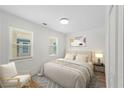 Cozy bedroom featuring light-filled windows, neutral decor, and a comfortable queen-sized bed at 1024 Herndon Nw St, Atlanta, GA 30318