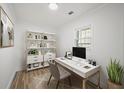 Well-lit home office featuring a modern desk, stylish shelving, and a comfortable chair at 1024 Herndon Nw St, Atlanta, GA 30318