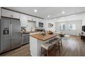 Bright eat-in kitchen featuring stainless steel appliances, white cabinets, and a butcher block island at 1024 Herndon Nw St, Atlanta, GA 30318