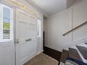 Bright foyer with classic trim, white paneled wall and sidelight windows next to front door at 12 Valley Forge Nw Pl # 215, Atlanta, GA 30318