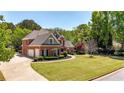 Expansive lawn and a circular driveway enhance the curb appeal of this brick home at 222 Rippling Nw Dr, Marietta, GA 30064