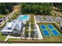 Aerial view of community clubhouse, pool, tennis courts and parking lot at 5345 Keepsake Court, Cumming, GA 30040