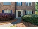 Inviting townhouse entrance with mature landscaping, pine straw and dark shutters at 743 Pecan Knoll Dr # 5, Marietta, GA 30008