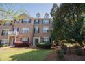 Charming brick townhouse with lush landscaping, dark shutters and a inviting front entrance at 743 Pecan Knoll Dr # 5, Marietta, GA 30008