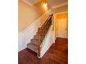 Hallway staircase featuring hardwood flooring and wood and iron railings at 743 Pecan Knoll Dr # 5, Marietta, GA 30008