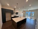 Open kitchen featuring a large island, modern appliances, and a light-filled dining area at 123 Beardon Circle # 159, Atlanta, GA 30316