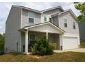 Charming two-story home featuring a gray exterior, attached garage, and well-maintained front yard at 23 Oxford Ln, Kingston, GA 30145