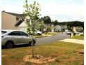 A quiet residential street featuring a variety of well-maintained homes and parked cars at 23 Oxford Ln, Kingston, GA 30145