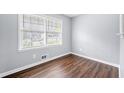 Bright bedroom features a large window and stylish, dark wood-look flooring at 2352 S Hairston Rd, Decatur, GA 30035