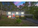 Charming home with a bright red door, carport, and well-maintained landscaping at 2352 S Hairston Rd, Decatur, GA 30035
