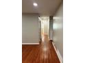 Hallway featuring hardwood floors connecting different areas of the home at 2512 Montezuma Cir, Ellenwood, GA 30294