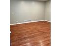 Spacious room featuring gleaming hardwood flooring and neutral paint at 2512 Montezuma Cir, Ellenwood, GA 30294