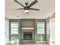Living room features a brick fireplace and hardwood floors with a ceiling fan at 622 Jockey Ln, Auburn, GA 30011