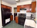 Galley-style kitchen features stainless appliances, dark wood cabinetry, and stylish backsplash at 3875 Ivy Run Cir, Duluth, GA 30096