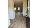 Inviting entryway with wood-look flooring leading to the staircase and living area, offering a seamless transition at 390 River Walk Farm Parkway Lot 47, Covington, GA 30014