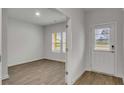 View into the home showcasing the floors, an entry door, and a window overlooking the front yard at 663 Egrets Landing Lot #55, Covington, GA 30014