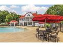 Recreational pool area with water features, lounge seating, umbrellas, and chairs for Gathering gatherings at 663 Egrets Landing Lot #55, Covington, GA 30014