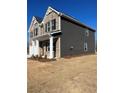 Side view of a two-story home highlighting gray siding, brick accents and manicured lawn at 669 Egrets Lot 56 Lndg, Covington, GA 30014