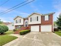 Charming two-story home featuring a brick facade, two-car garage, and well-maintained landscaping at 6367 Deshong Dr, Lithonia, GA 30058
