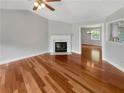 Cozy living room with fireplace, neutral walls, and hardwood floors at 6367 Deshong Dr, Lithonia, GA 30058