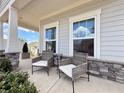 Relaxing front porch with a comfortable seating area, perfect for enjoying the outdoors at 5515 Allegre Pl, Cumming, GA 30028