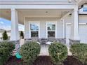 Inviting front porch seating area with stone accents, creating a cozy outdoor space at 5515 Allegre Pl, Cumming, GA 30028