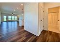 Open-concept living space with hardwood floors, white trim, and a view of the bathroom and backyard at 5515 Allegre Pl, Cumming, GA 30028