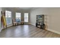 Bright living room with light floors, large windows, and decorative shelving and seating at 5976 Princeton Run Trl, Tucker, GA 30084
