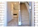 Inviting entryway featuring wood-look floors and a staircase leading to the second floor at 685 Egrets Lot 58 Lndg, Covington, GA 30014