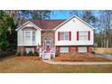 Charming two-story home with brick accents, a red front door, and a well-manicured lawn at 1074 Fieldstone Dr, Canton, GA 30114