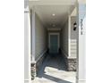 Welcoming front entrance with a stone base, gray siding, and a teal front door at 2108 Amaryllis Dr, Grayson, GA 30017