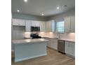 Modern kitchen with stainless appliances, custom white cabinets, and a center island at 2108 Amaryllis Dr, Grayson, GA 30017