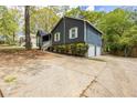 Lovely home with an attached two-car garage and a long driveway surrounded by mature landscaping and natural light at 2724 Bomar Rd, Douglasville, GA 30135