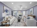 Bright and spacious living room featuring recessed lighting, a ceiling fan, fireplace, and neutral decor for versatile styling at 2724 Bomar Rd, Douglasville, GA 30135