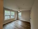 Bright bedroom featuring hardwood floors, neutral walls, and two large windows at 455 Firefly Cir # 39, Alpharetta, GA 30009