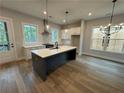 Contemporary kitchen with a large island, stainless steel appliances, and hardwood floors at 455 Firefly Cir # 39, Alpharetta, GA 30009