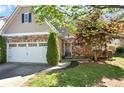 Charming home featuring a stone facade, two-car garage, and well-manicured lawn at 207 Cole Ct, Canton, GA 30114