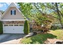 Charming home featuring a stone facade, two-car garage, and well-manicured lawn at 207 Cole Ct, Canton, GA 30114