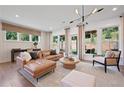 Comfortable living room with large windows, a stylish leather sofa, and modern decor at 114 Briargate Dr, Johns Creek, GA 30097