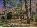Two-story brick home nestled among mature trees, boasting a balcony and ample windows for a bright, airy feel at 2210 Leafmore Dr, Decatur, GA 30033