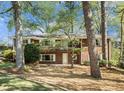 Two-story brick home nestled among mature trees, boasting a balcony and ample windows for a bright, airy feel at 2210 Leafmore Dr, Decatur, GA 30033