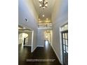 Grand two-story foyer featuring hardwood floors and views into other areas of the home at 13015 Fox Rd, Alpharetta, GA 30005