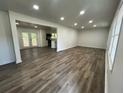Open-concept living room featuring recessed lighting, wood floors, and access to the deck at 185 Maple Wood Dr, Lawrenceville, GA 30046