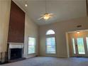 Inviting living room showcasing a brick fireplace, vaulted ceilings, and a view of the entrance at 1241 Baldridge Dr, Lawrenceville, GA 30044