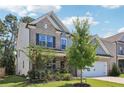 Beautiful two-story home featuring brick and siding accents, a well-kept lawn, and mature trees at 160 Avery Landing Way, Canton, GA 30115