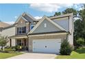 Attractive home featuring brick and siding accents, a well-kept lawn, and a two-car garage at 160 Avery Landing Way, Canton, GA 30115